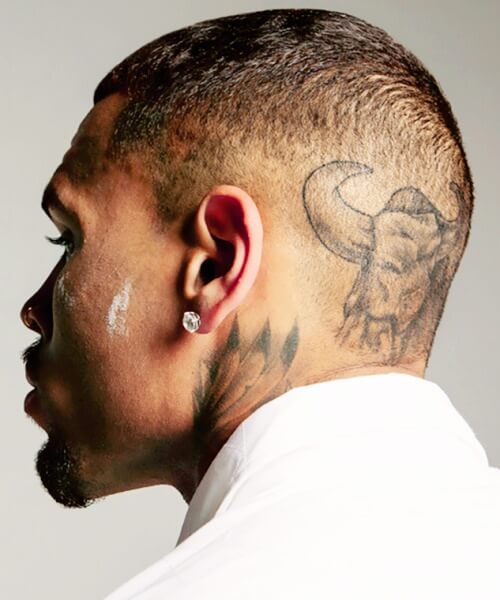 chris brown fade haircut bald side part with tattooes hairstyle