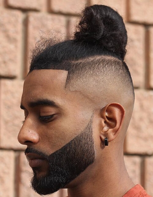 bald fade skin side part haircut with man bun line up beard