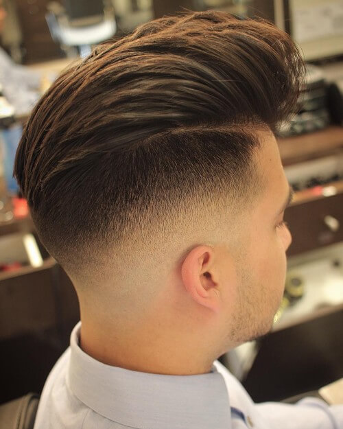 high wavy quiff men hairstyle with high bald fade haircut