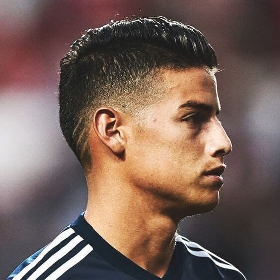 james rodriguez taper fade side part haircut with design.